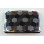 A sterling silver cigarette case, inlaid with various metals in a hexagonal design,