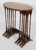 An Edwardian walnut quartetto of table, the oval top with string inlay and bamboo effect legs,