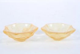 A pair of Lalique pale orange pressed glass dishes, of flower head form,