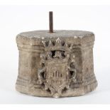 A carved stone plinth, alabaster or marble, possibly 17th century, with a carved crest to the front,