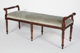 A Regency style mahogany window seat, with foliated carved handles and legs,