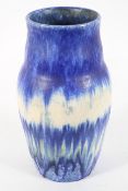 A Ruskin vase, of bulbous form, with a streaking and crystalline blue and white glaze,