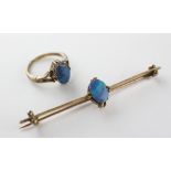 A yellow metal opal doublet single stone ring together with matching bar brooch.