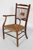 An Arts and Crafts style beech and ash Windsor chair, with spindle back, outswept arms,