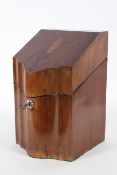 A George III mahogany knife box, of serpentine form, the cover inlaid with an urn,