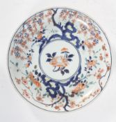 A Chinese Imari saucer dish, probably late 18th century, with flower, willow and prunus,