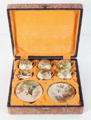 A Japanese Satsuma boxed coffee set, early 20th century, decorated with birds in foliage,