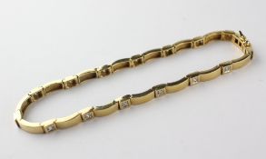 A yellow metal bracelet set with fifteen round brilliant cut diamonds
