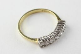 A yellow and white metal half hoop ring set with seven round brilliant cut diamonds