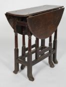 An oak gateleg table, possibly Queen Anne, the oval top on block and turned legs and stretchers,