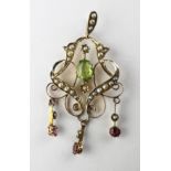 An Edwardian filigree pendant set with peridot and rhodolite garnet and finished with seed pearls.