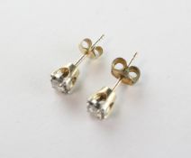 A yellow and white metal pair of stud earrings.