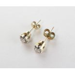 A yellow and white metal pair of stud earrings.
