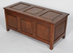 An oak three panel coffer, with three fielded panels, pin hinges and candle box interior,