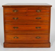 A Maple & Co Aesthetic style walnut chest of two short and three graduated long drawers