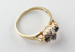 A yellow metal dress ring set with marquise/baguette cut sapphires and finished with diamonds.