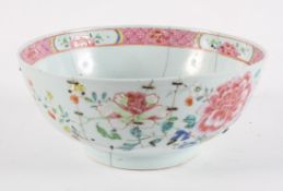 A Chinese Famille Rose fruit bowl, late 18th or early 19th century, decorated with floral sprays,