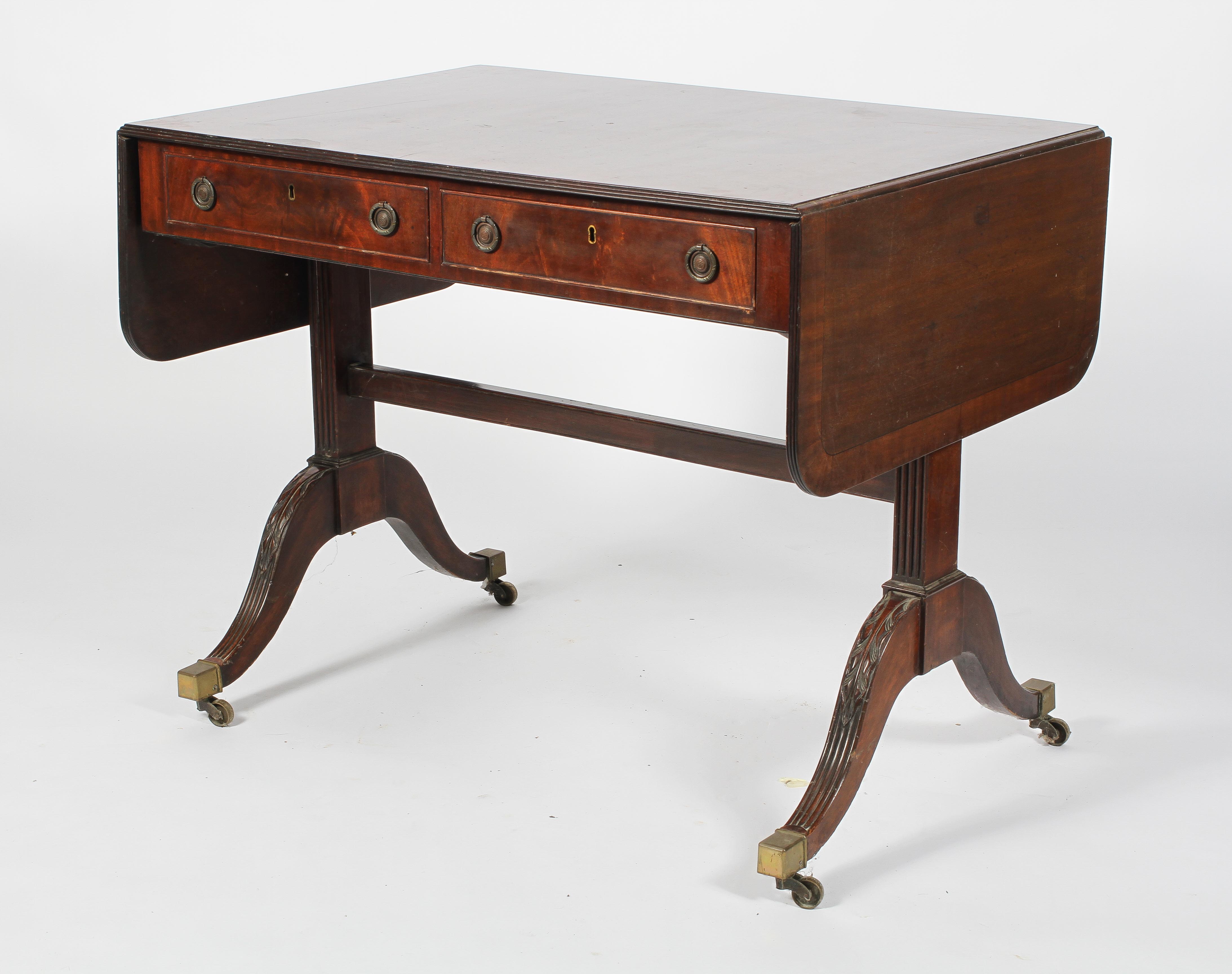A Regency style mahogany and cross banded sofa table, drop leaves and two true drawers,