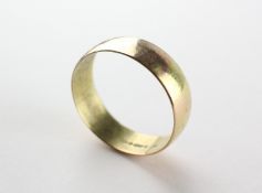 A yellow metal 7.5mm D shape wedding ring. Hallmarked 9ct gold, London, 1973.