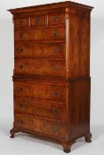 A George II style walnut and feather banded chest on chest,