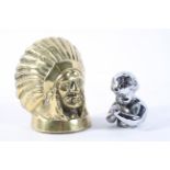 A brass car mascot, cast as a Native American Indian chief's head,