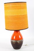 A 1960's vintage West German pottery table lamp by Carstens Tonniestoff, having a bulbous form,