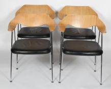 A set of four Robin Day oak and chrome dining chairs with black leather seat,