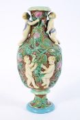 A Continental majolica vase, late 19th century, decorated with cherubs amongst briar roses,