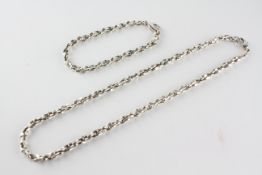 A matching sterling silver necklace and bracelet set of abstract design.