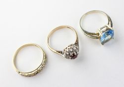 A collection of three dress rings of variable styles.