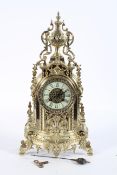 A French brass mantel clock, the ivorine dial on a brass eight day movement, striking to a bell,