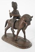 A Persian bronze figure of a man on horseback,