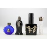 A collection of four silver mounted glass scent bottles, mainly early 20th century,