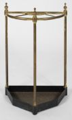 A brass and iron umbrella stand, of semi circular form, with drip tray,