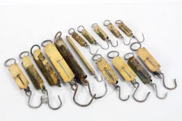 A collection of fifteen brass spring balances, by various markers, including Salters,