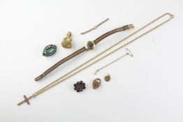 A collection of costume jewellery to include a cross and chain, A gem set seal, A padlock,