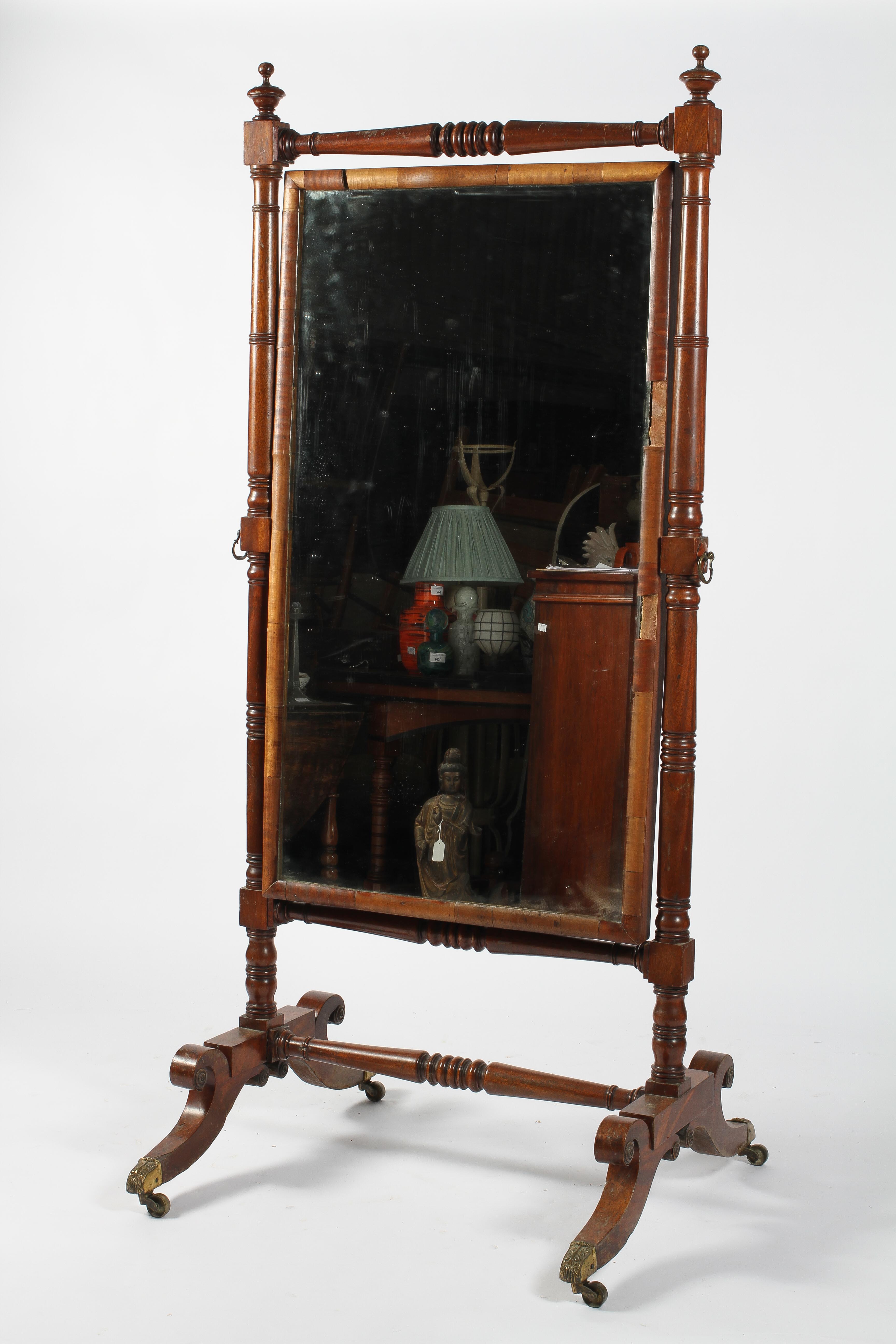 A mahogany cheval mirror, early/mid 19th century, the rectangular plate in a turned frame,