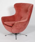 A 1960's vintage swivel egg chair having button backed upholstery