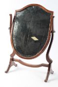 A Regency style shield shaped toilet mirror, with a mahogany frame,