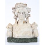 A white marble bust of a young lady wearing a lace bonnet, on a mottled green marble base,