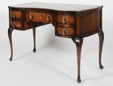 A Queen Anne style walnut dressing table, of serpentine form, with five drawers above cabriole legs,