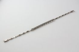 A white metal centrepiece bracelet.