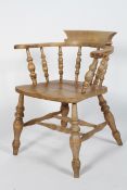 An elm smoker's bow chair, stamped Glenister Maker Wycombe, with raised back, scrolled arms,