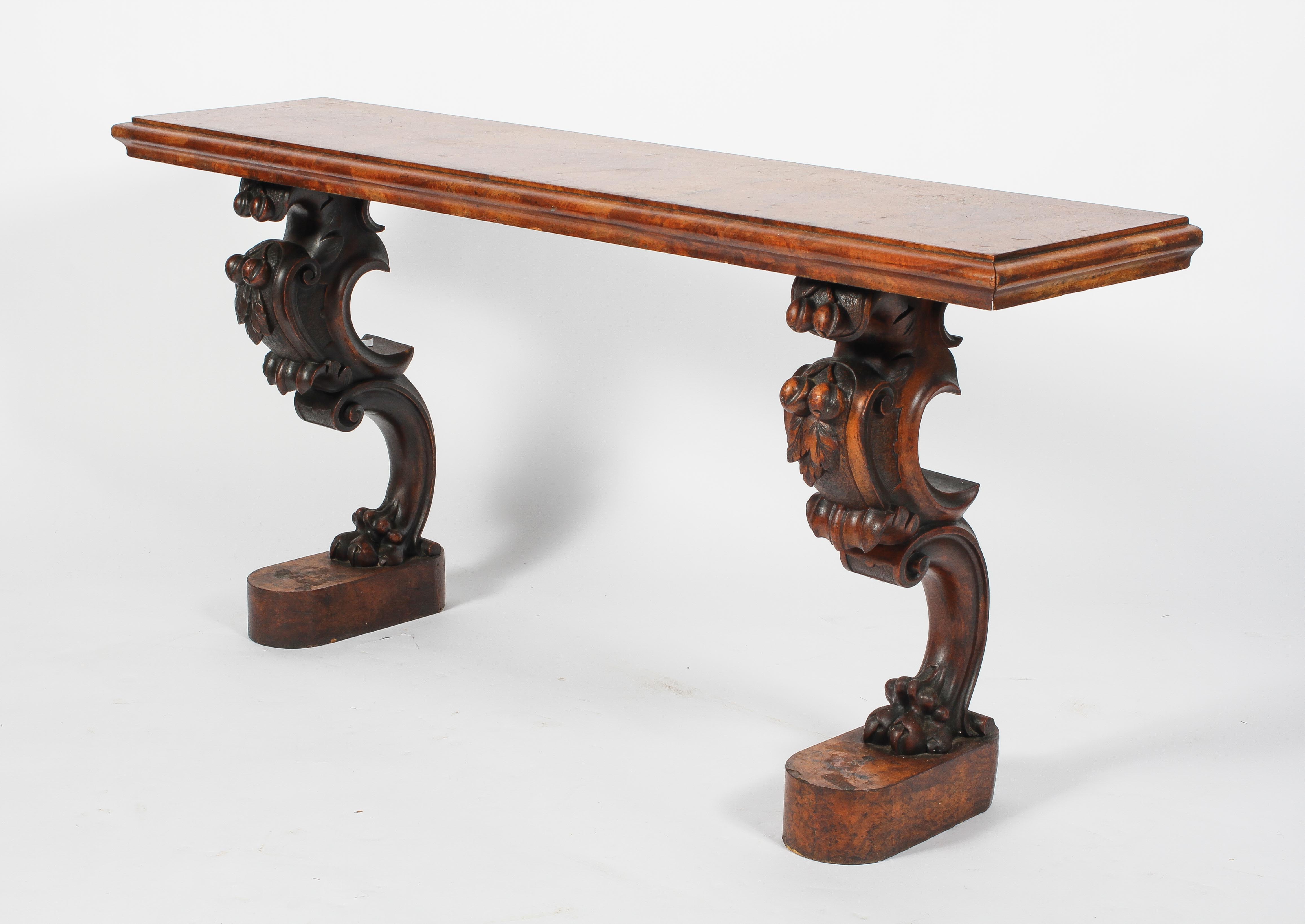 A Victorian walnut low side table, the moulded top on scrolling legs with lion paw feet,