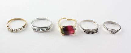 A collection of rings to include A blue topaz and diamond ring;