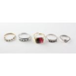 A collection of rings to include A blue topaz and diamond ring;