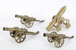Four miniature brass cannons, in various styles,