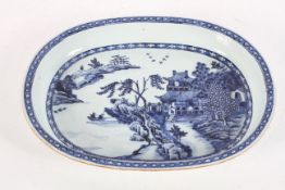 A Chinese blue and white dish, 18th century, of oval form, painted with a lakeside pavilion,