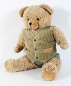 A Canadian golden plush bear, with corduroy waistcoat, hinged joints,