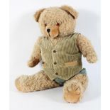 A Canadian golden plush bear, with corduroy waistcoat, hinged joints,